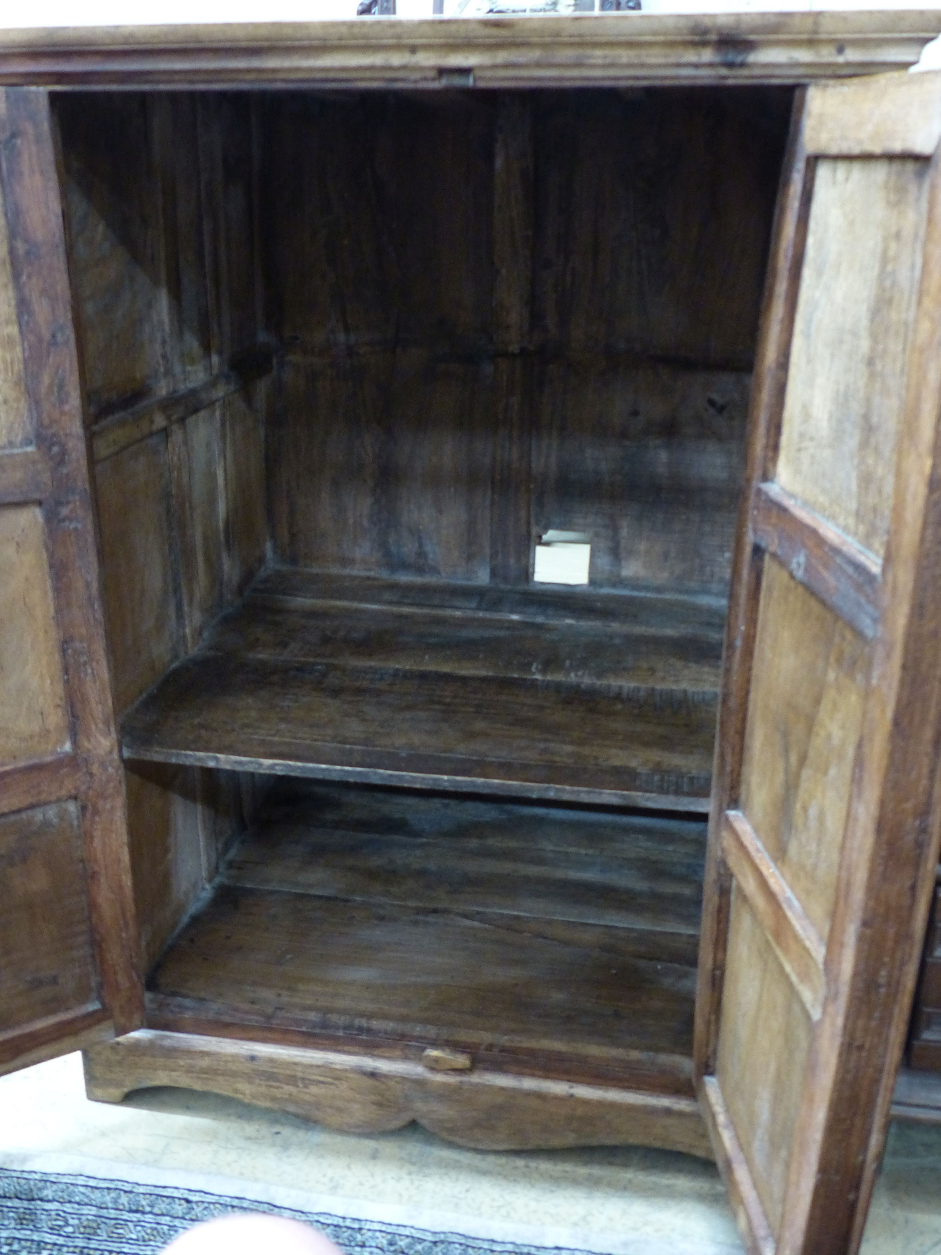 An Indian hardwood carved two door cabinet, width 77cm